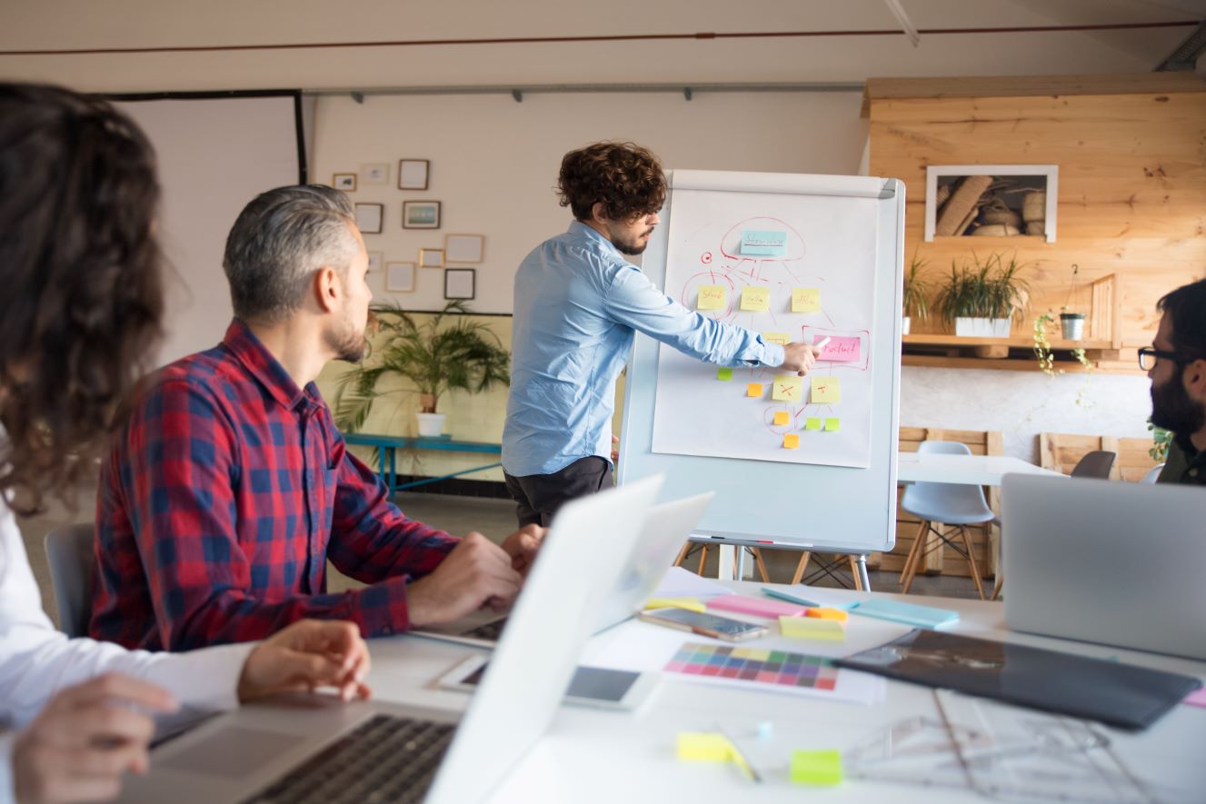 creative-group-discussing-ideas-project-boardroom – Copie une petite équipe en pleine session de travail collectif dynamique